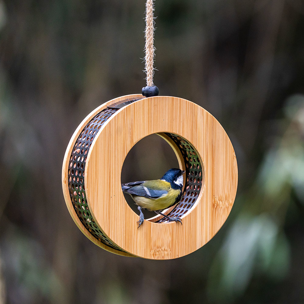 Child smiles while presenting the assembled nest box building kit